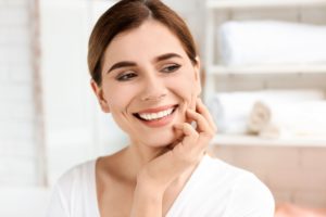 a woman smiles with perfect teeth