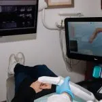patient in chair with computer screen