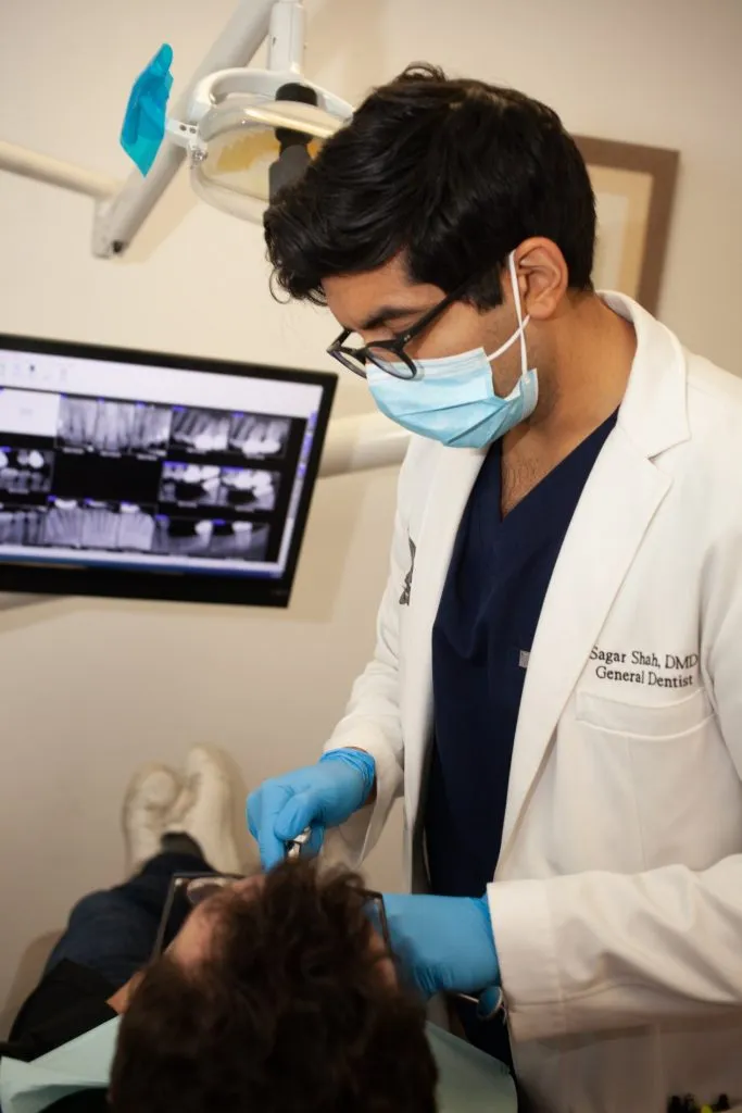 Dr. Shah working on a patient in a dental chair