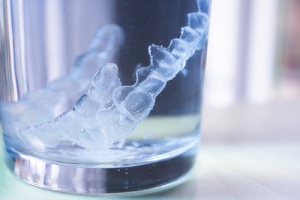 Invisalign tray in glass of water