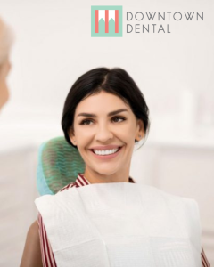 Woman smiling at dentist in exam chair